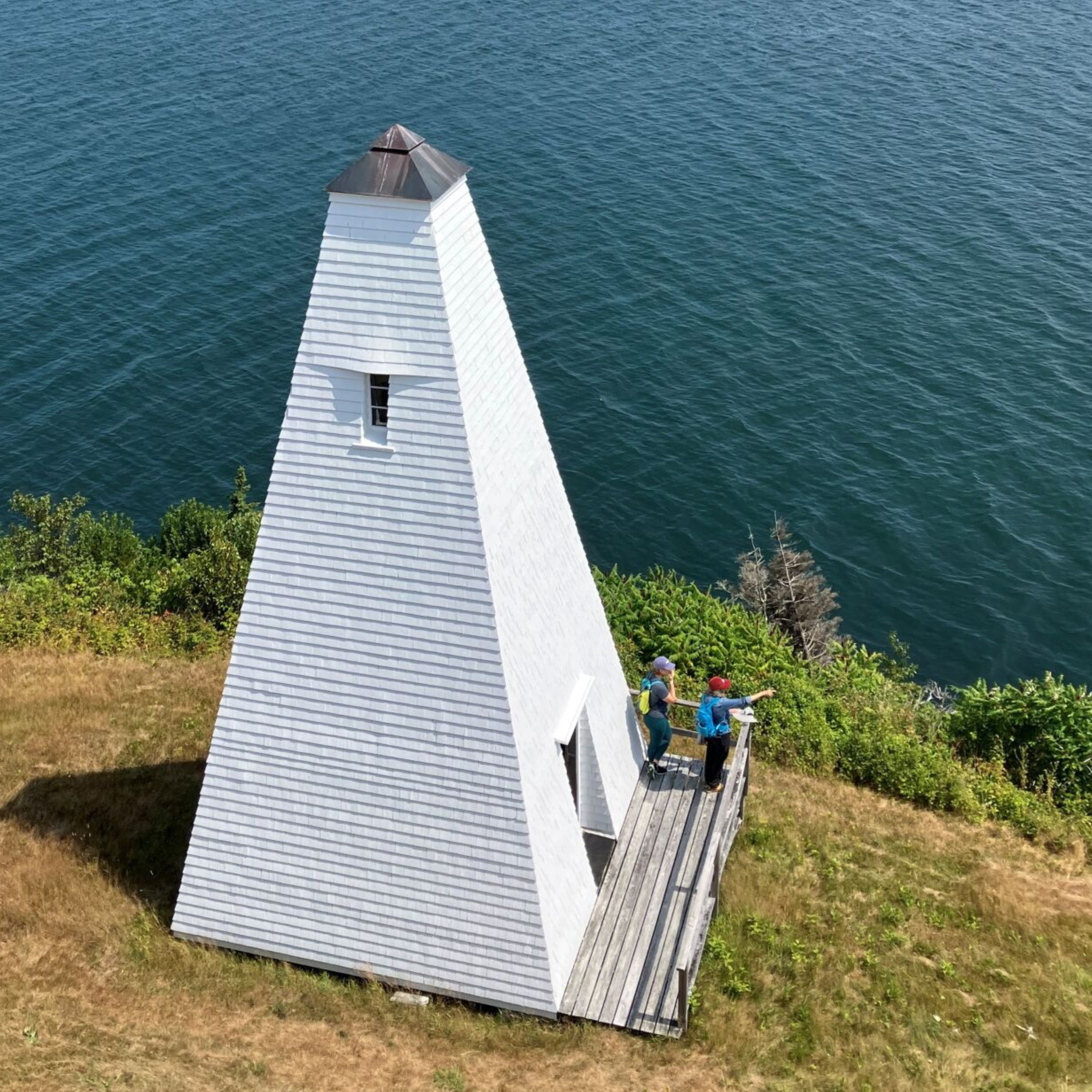 1 Seen from the top of Eagle Island Light, two visitors on the deck of the fog bell tower take in the water views